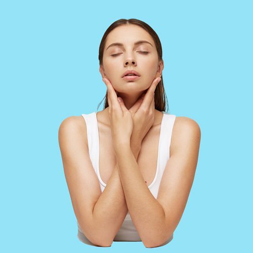 close-up-of-woman-with-perfect-healthy-fresh-skin-sits-at-the-table-hands-crossed-and-touching-face close-up-of-woman-with-perfect-healthy-fresh-skin-sits-at-the-table-hands-crossed-and-touching-face